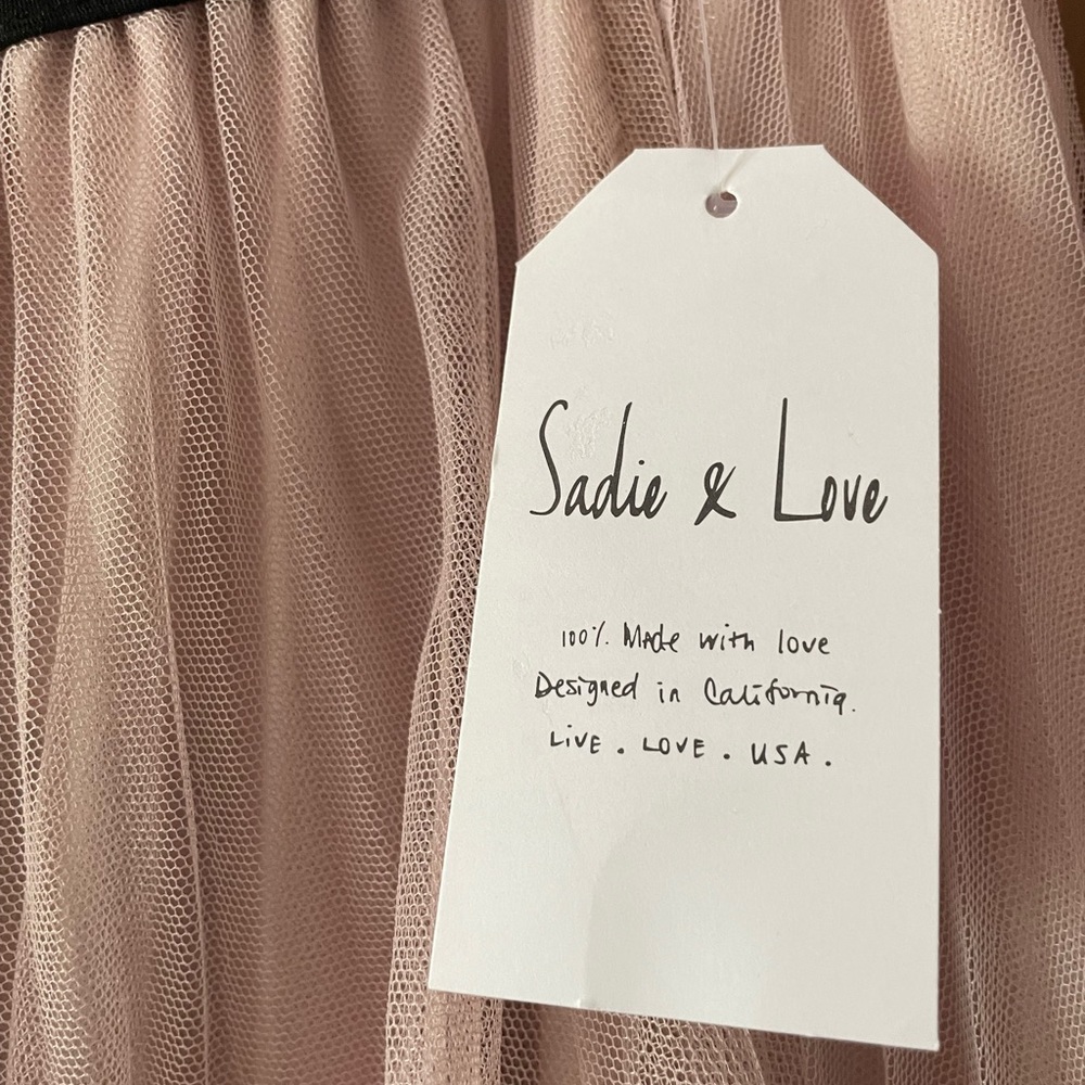 Brand new! Super cute light pink skirt with pearl embellishments.